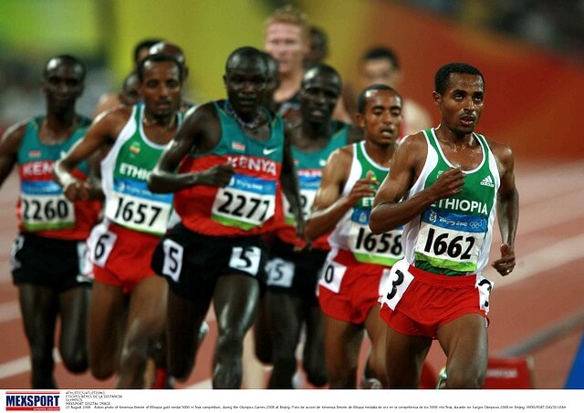 Action photo of Kenenisa Bekele of Ethiopia gold medal 5000 m final competition, during the Olympics Games 2008 at Beijing. Flickr / CONADEoficial