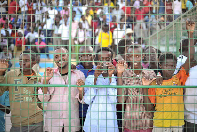 Young men watch a football match in Mogadishu, Somalia.
