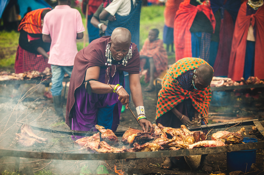 Meat being cooked at market. The handling of raw meat and the ...